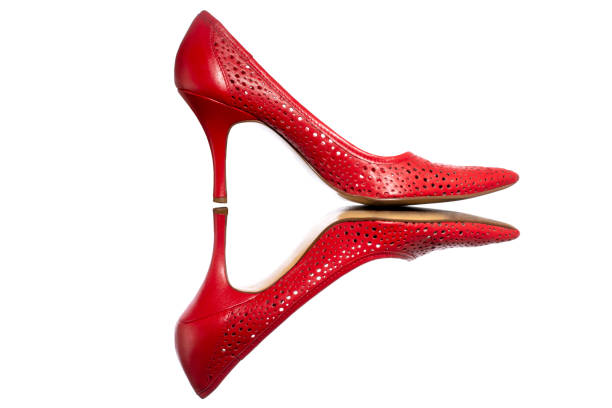 istock Female red high heel shoes on white background 1350539232