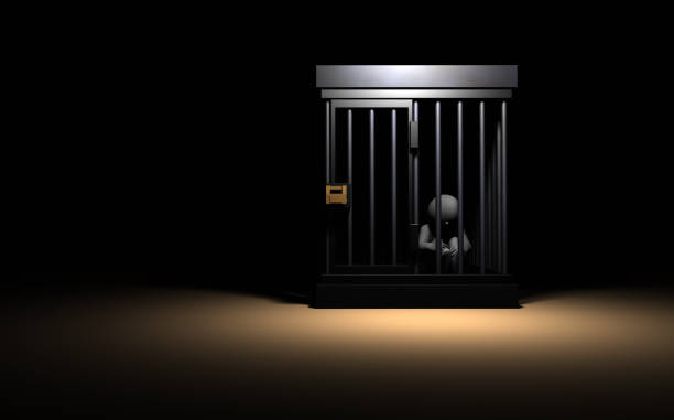A person who is imprisoned in prison. He is lonely alone. 3D rendering.