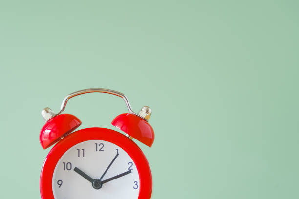 istock portion of red analog alarm clock on green background with copy space, punctuality, on time, countdown concept 1350543099