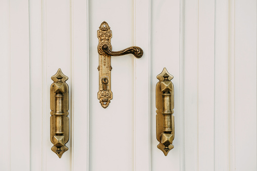 Antique interior doorknob on an old wooden door