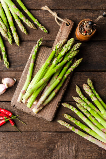 istock Asparagus on old wooden table. Top view 1350548839