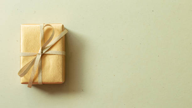 istock Gold gift box on khaki green background. top view, copy space 1350549922