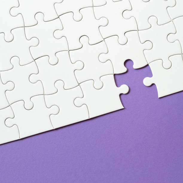 istock Set of white puzzle pieces and last one piece 1350549980