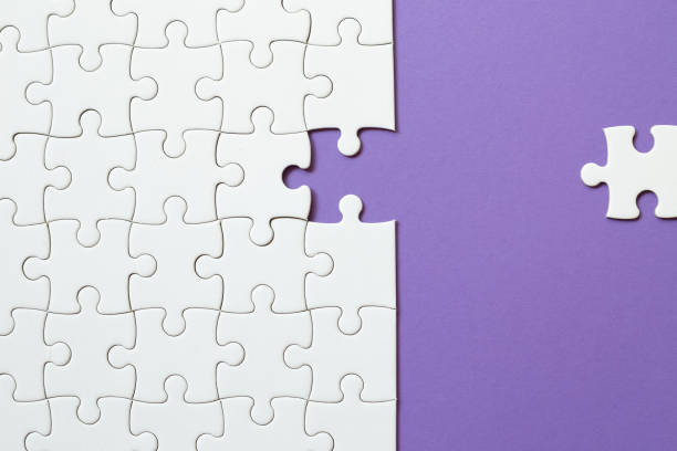 istock Set of white puzzle pieces and last one piece 1350549994