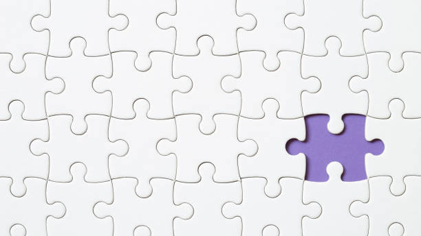 istock Set of white puzzle pieces and last one piece 1350550010