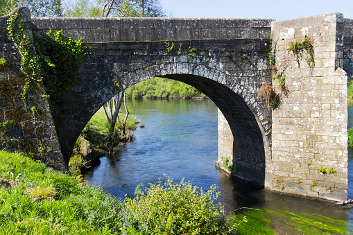 Close-up view of an stone arch of Pontevea medieval foot bridge  over Ulla river, Teo, A Estrada, Galicia, Spain. XIV century.  Camino de Santiago, camino portugués.