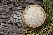 Thai Jasmine rice  (white rice) in wooden bowl and on wooden table.