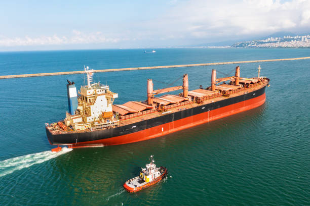 Aerial view of large bulk carrier approaching port. Aerial view of large bulk carrier approaching port. Bulk carrier ship in transit. bulk carrier stock pictures, royalty-free photos & images