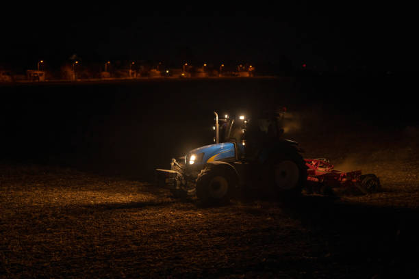 istock Tractor Plowing Agricultural Field in the Evening 1350557962