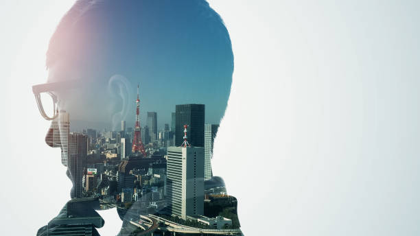 istock Silhouette of thinking man and modern cityscape. Double exposure. 1350558293