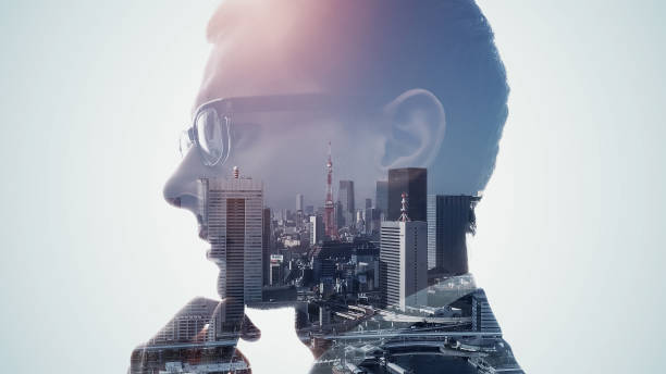 istock Silhouette of thinking man and modern cityscape. Double exposure. 1350558327