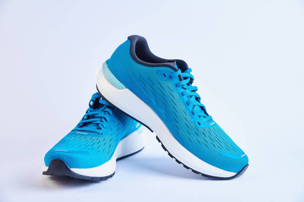 Pair of blue running sneakers on white background isolated Blue running sneakers on white. Pair of sport male shoes for fitness on white background trainer stock pictures, royalty-free photos & images