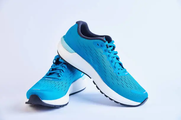 Photo of Pair of blue running sneakers on white background isolated