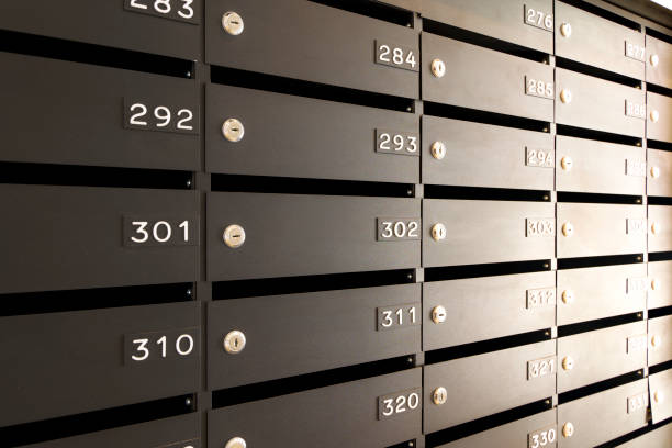 istock Mailboxes for letters and correspondence. Modern black mailboxes with numbers in the lobby of a residential or office building 1350563836