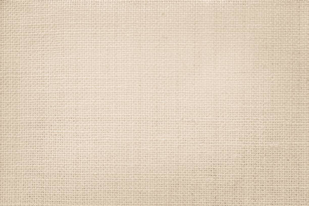 istock Jute hessian sackcloth canvas woven texture pattern background in light beige cream brown color blank empty 1350566594