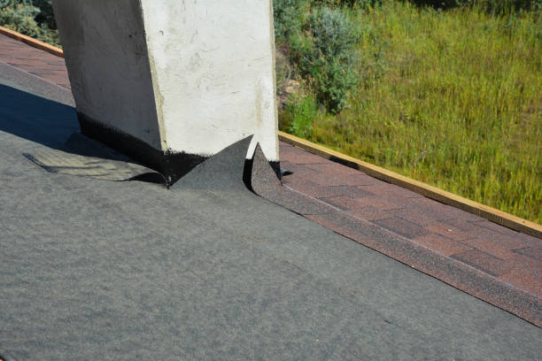 istock Asphalt roofing shingles installation and waterproofing chimney problem area.  Covering the roof with asphalt shingles on installed underlayment around chimney using a waterproofing flashing. 1350567157
