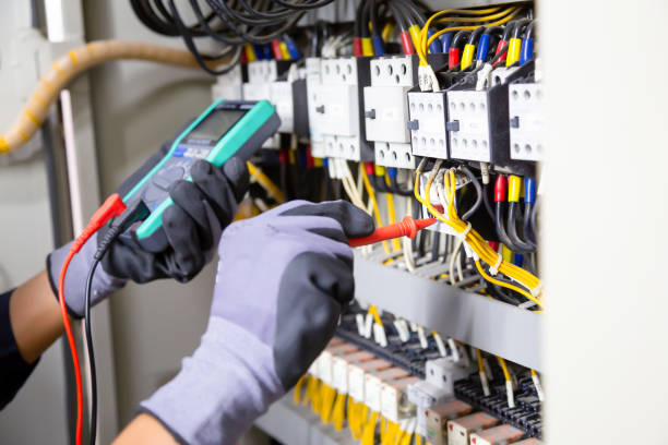 istock Electrician engineer tests electrical installations and wires on relay protection system. Adjustment of scheme of automation and control of electrical equipment. 1350568370