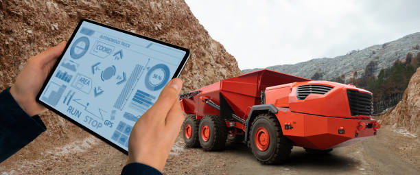 Man controls autonomous mining truck stock photo