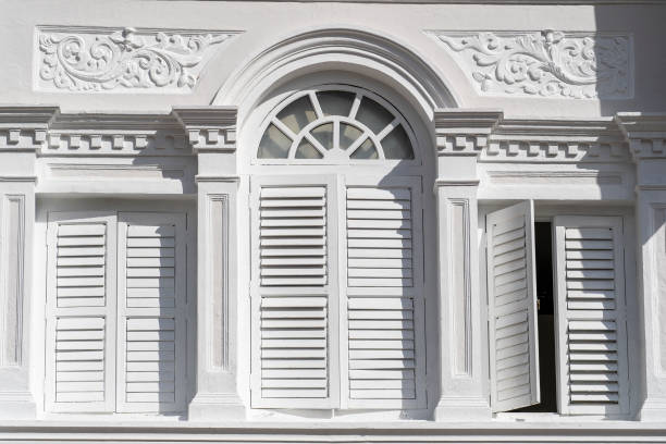 istock Window with white wooden shutters on wall building, Singapore 1350572597