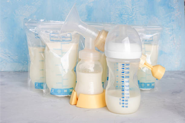 Bags with breast milk. Breast pump on yellow background. Milk bank. Expressing breast milk. Breast-feeding. Freezing and storing milk. Donated. Copyspace Bags with breast milk. Breast pump on yellow background. Milk bank. Expressing breast milk. Breast-feeding. Freezing and storing milk. Donated. Copyspace breast milk stock pictures, royalty-free photos & images