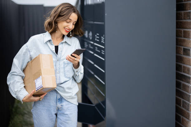 istock Caucasian woman with parcel near post terminal 1350579795