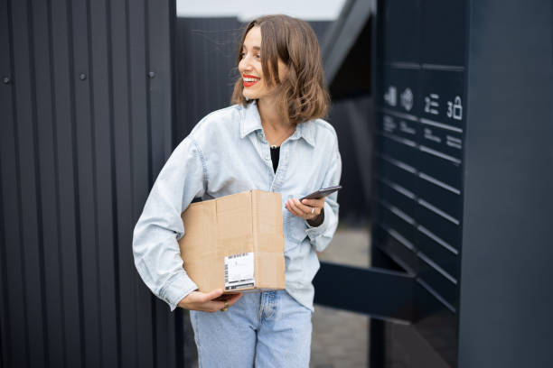 istock Caucasian woman with parcel near post terminal 1350579837