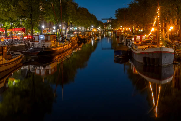 istock Amsterdam Canal With Boats at Night 1350579871