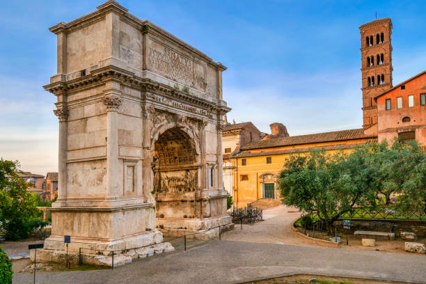 the imposing arch of titus along the via sacra in the roman forum in the heart of ancient rome - arch of titus imagens e fotografias de stock