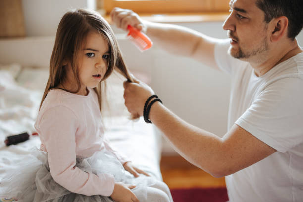 istock Father brushing his little daughter's hair 1350580989
