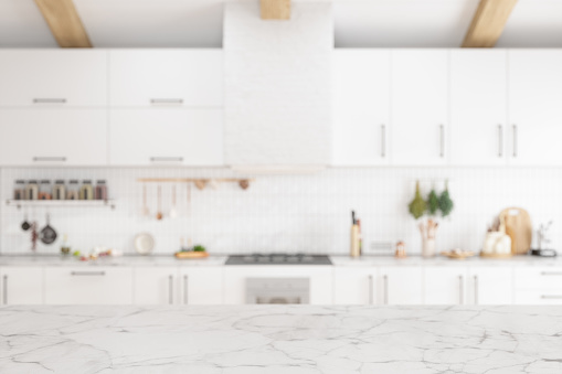 Empty White Marble Surface With Blurred Kitchen Background