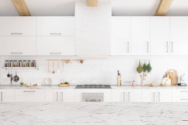 Empty White Marble Surface With Blurred Kitchen Background Empty White Marble Surface With Blurred Kitchen Background kitchen counter stock pictures, royalty-free photos & images
