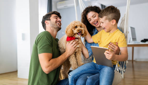 istock Happy family using technology devices together at home. 1350583575