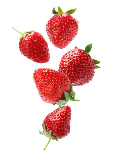 istock Set with ripe strawberries falling on white background 1350583938