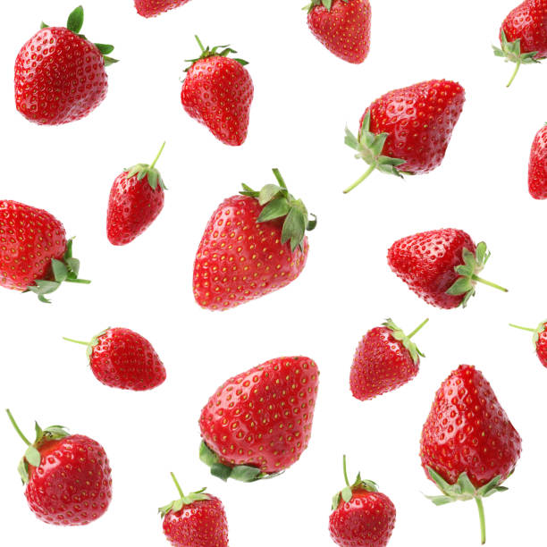 set with ripe strawberries falling on white background - strawberry stockfoto's en -beelden