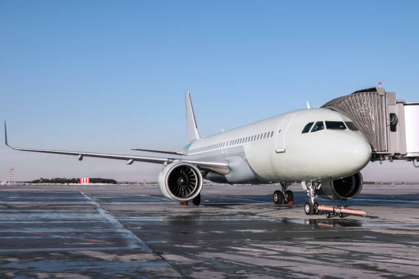 istock Passenger airliner with towbar at the jetway 1350584734