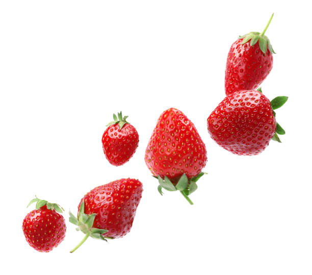 istock Set with ripe strawberries falling on white background 1350585683