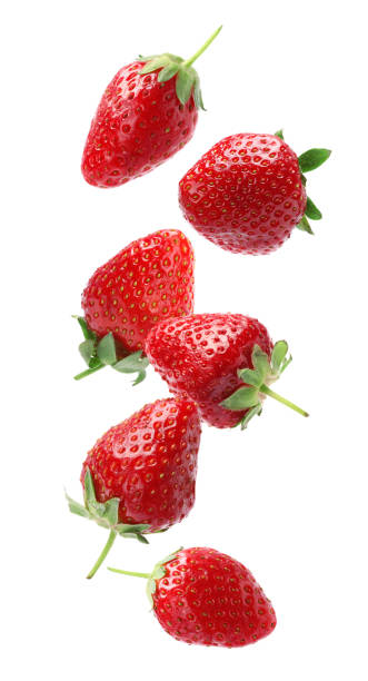 istock Set with ripe strawberries falling on white background 1350585970