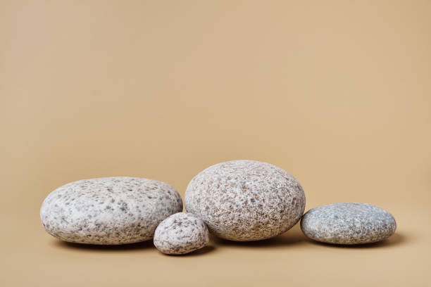 istock Rounded pebbles podium. Trending background for presentation of eco friendly and zero waste products in earth colors 1350586856