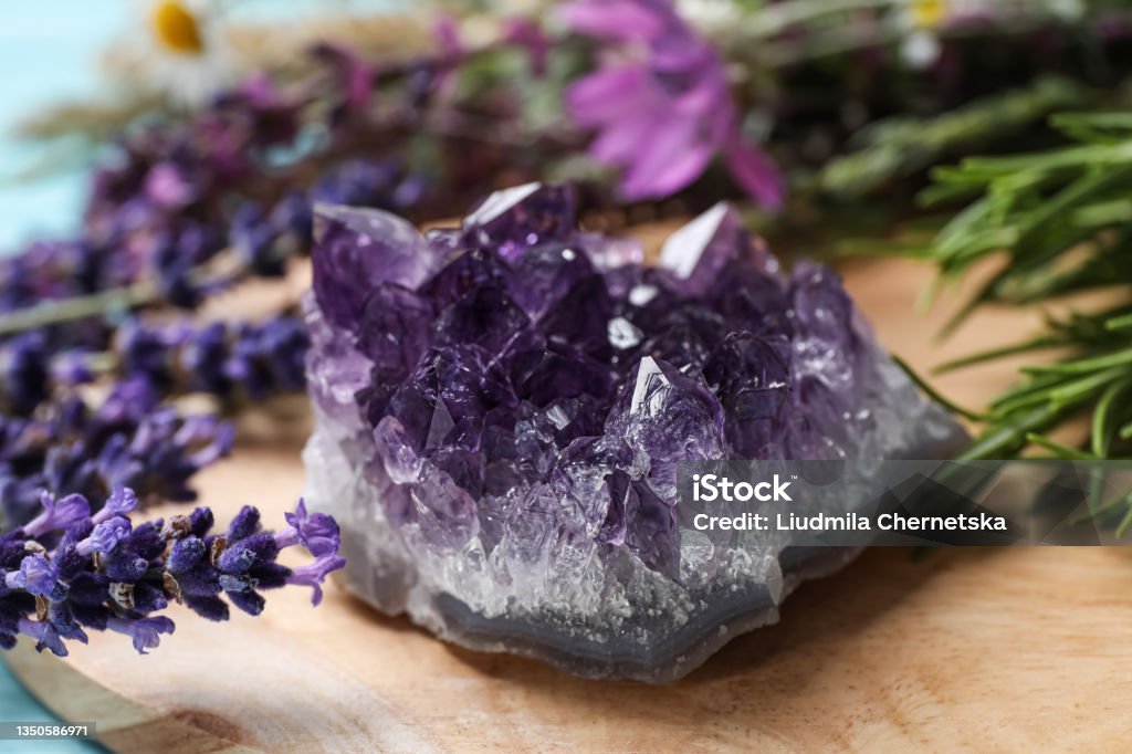 Amethyst and healing herbs on wooden board, closeup Amethyst Stock Photo