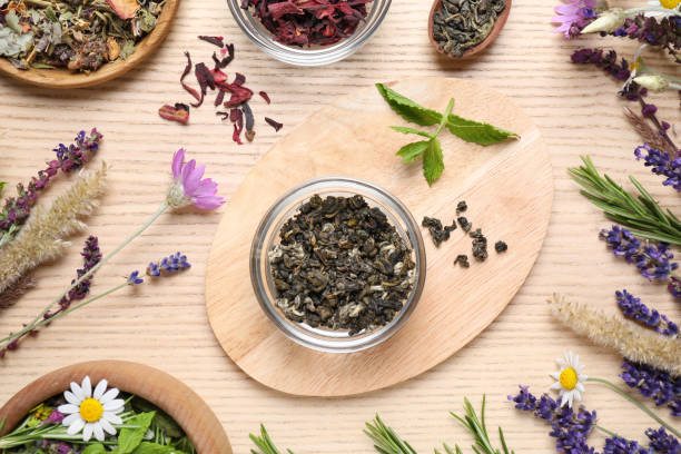 istock Flat lay composition with healing herbs on wooden table 1350587052