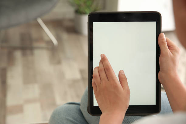 istock Woman working with modern tablet indoors, closeup. Space for design 1350587089