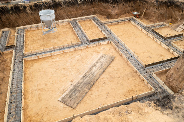 istock Foundation of future house. Pouring foundation with cement on construction site with crane, aerial view 1350592580
