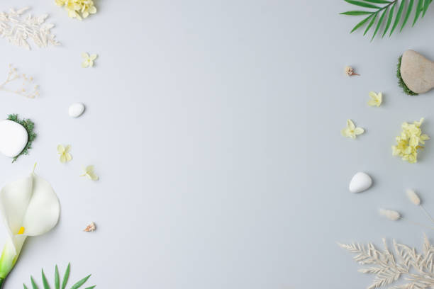 istock Cosmetic background with flowers, moss and stone on grey. Flat lay, copy space 1350595626