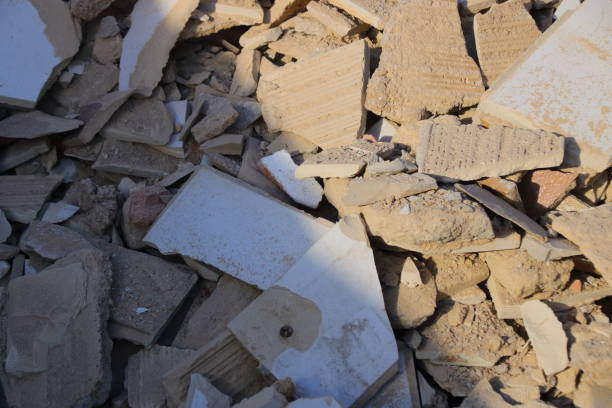 Tile remnants stored as construction rubble in a container for collection
