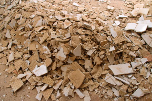 Tile remnants stored as construction rubble in a container for collection