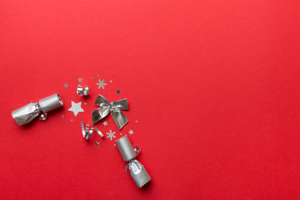 istock Christmas crackers with shiny confetti on color background, top view, copy space 1350597480