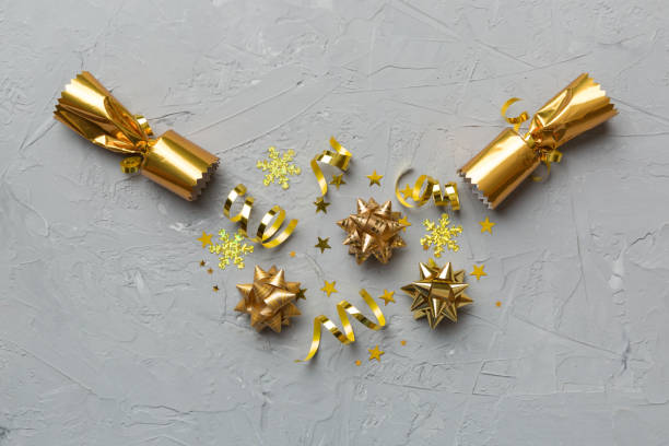 istock Christmas crackers with shiny confetti on color background, top view, copy space 1350597481