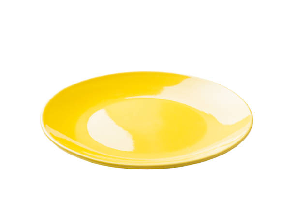 istock Yellow ceramic round plate isolated over white background. perspective view 1350597555