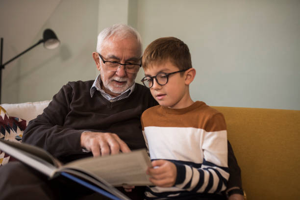 istock Senior man reading to his grandson 1350597854