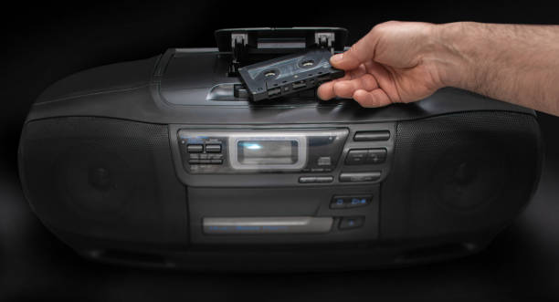 istock man puts a cassette in a tape recorder 1350598004